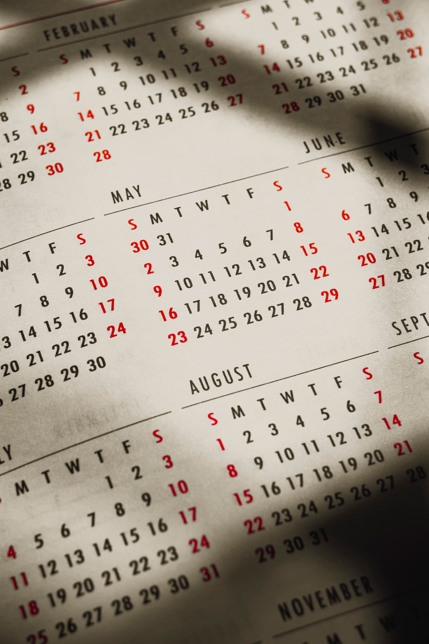 Paper calendar pages in soft shadows and sunbeams