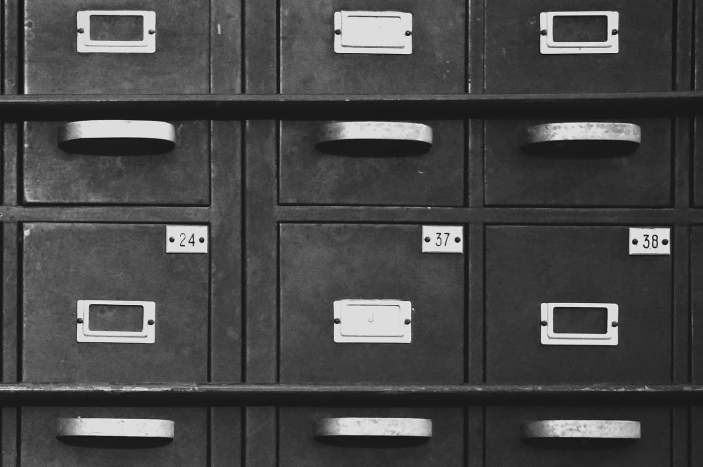 Numbered vintage metal filing cabinets photographed in black and white