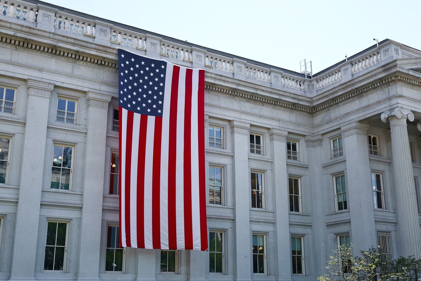An American flag hanging on a historic civic building.