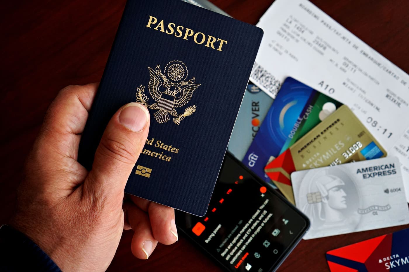 United States passport with travel documents laid out on a desk