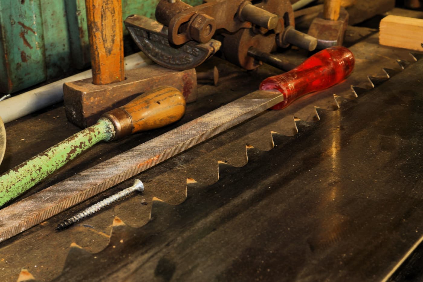 Vintage hand tools laid out on a wooden workshop bench