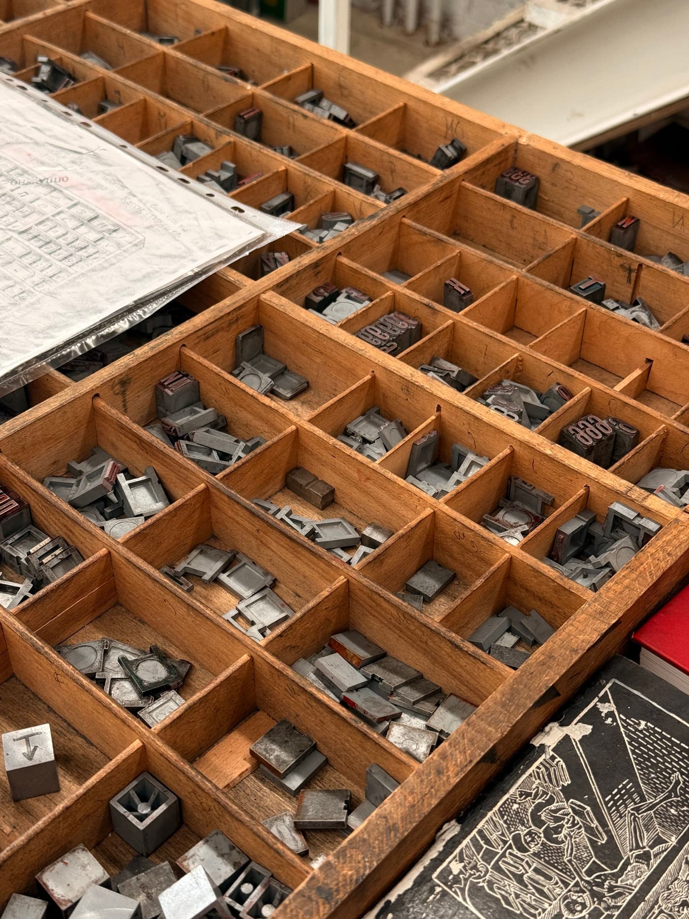 Vintage letterpress type blocks arranged in a wooden tray