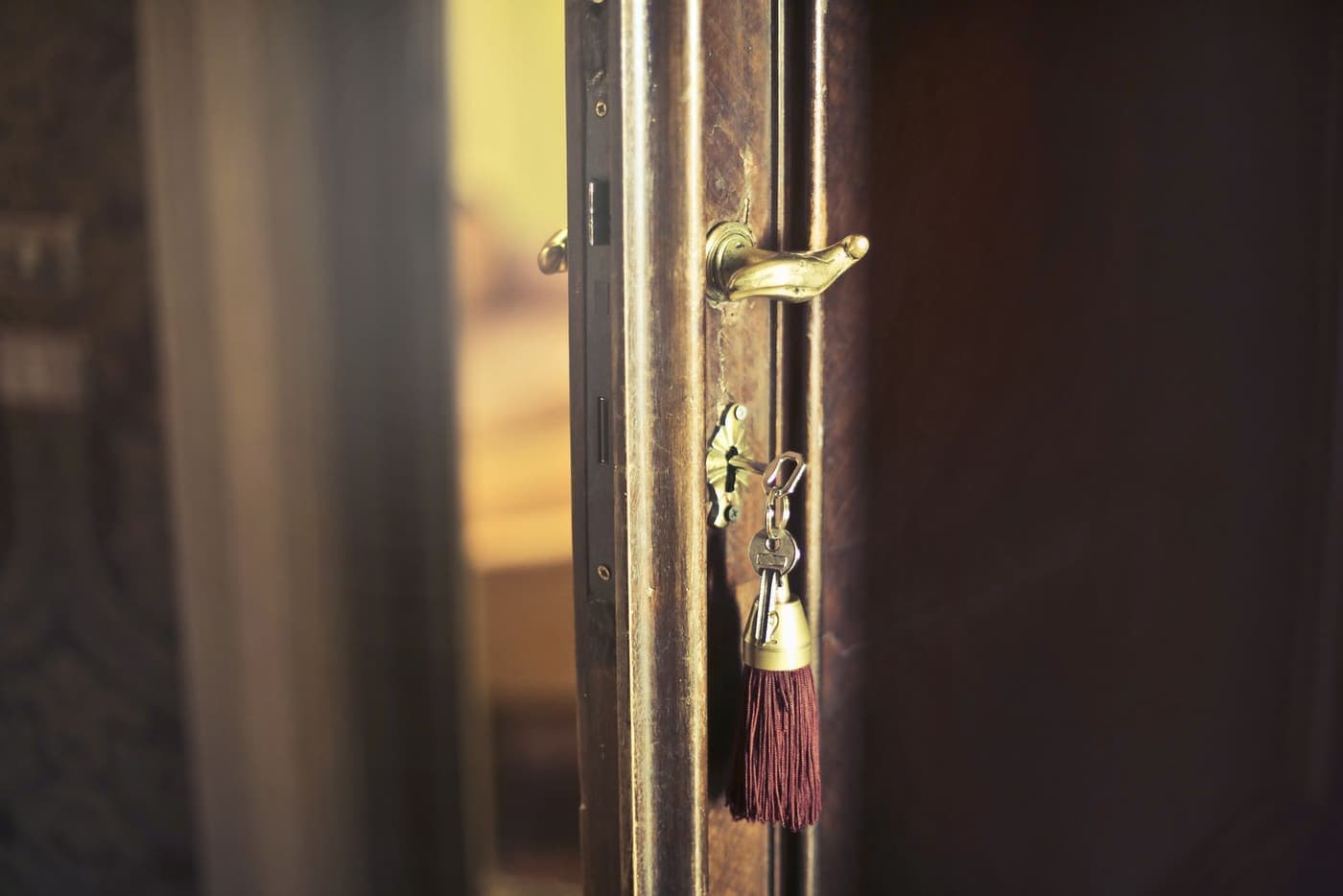 A key left in the lock of a front door.