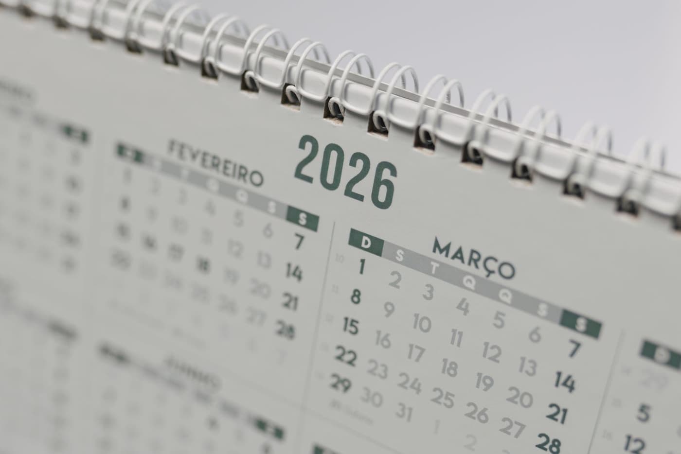 A desk calendar open on the months ahead.