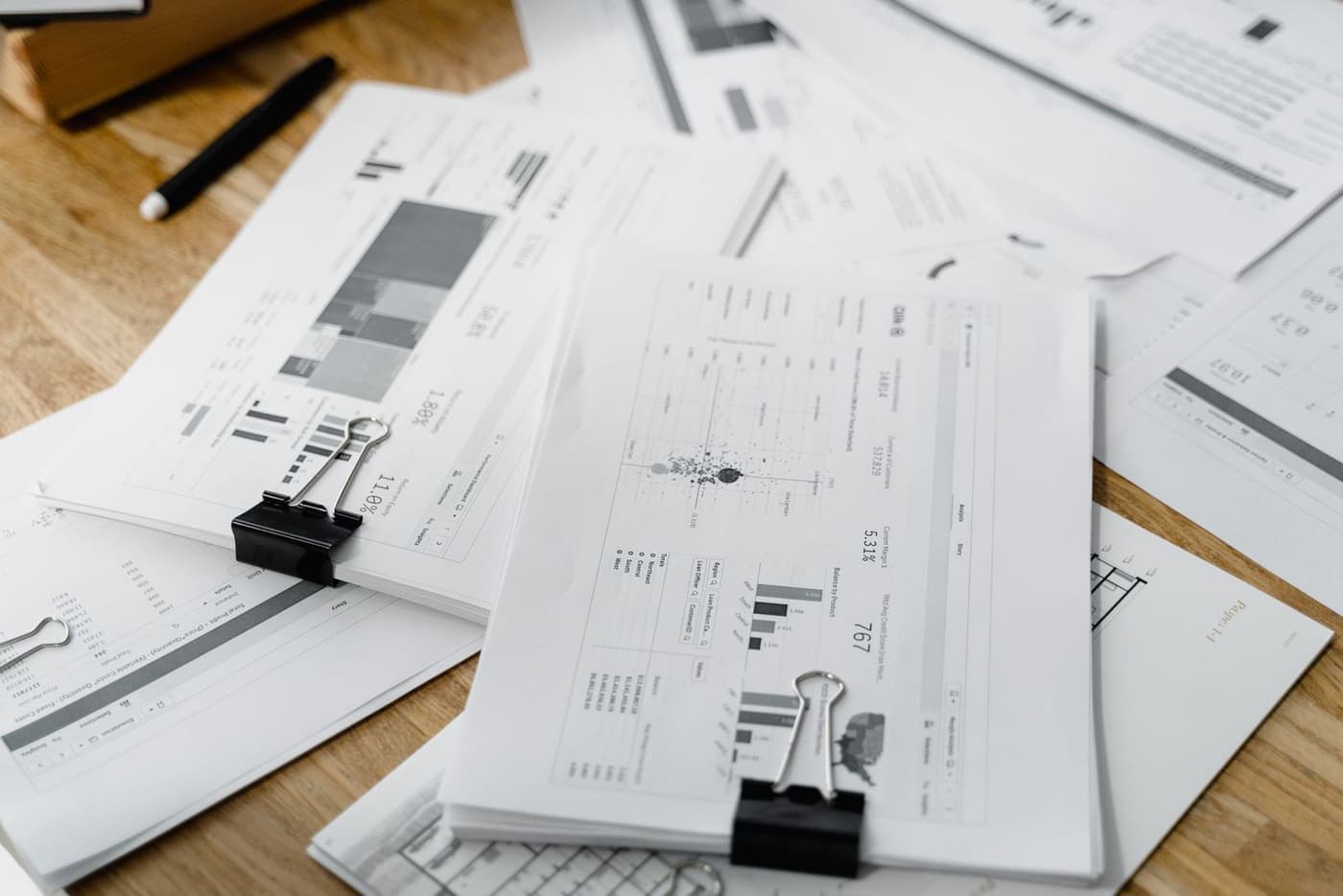 Anonymised earnings paperwork clipped together on a desk.