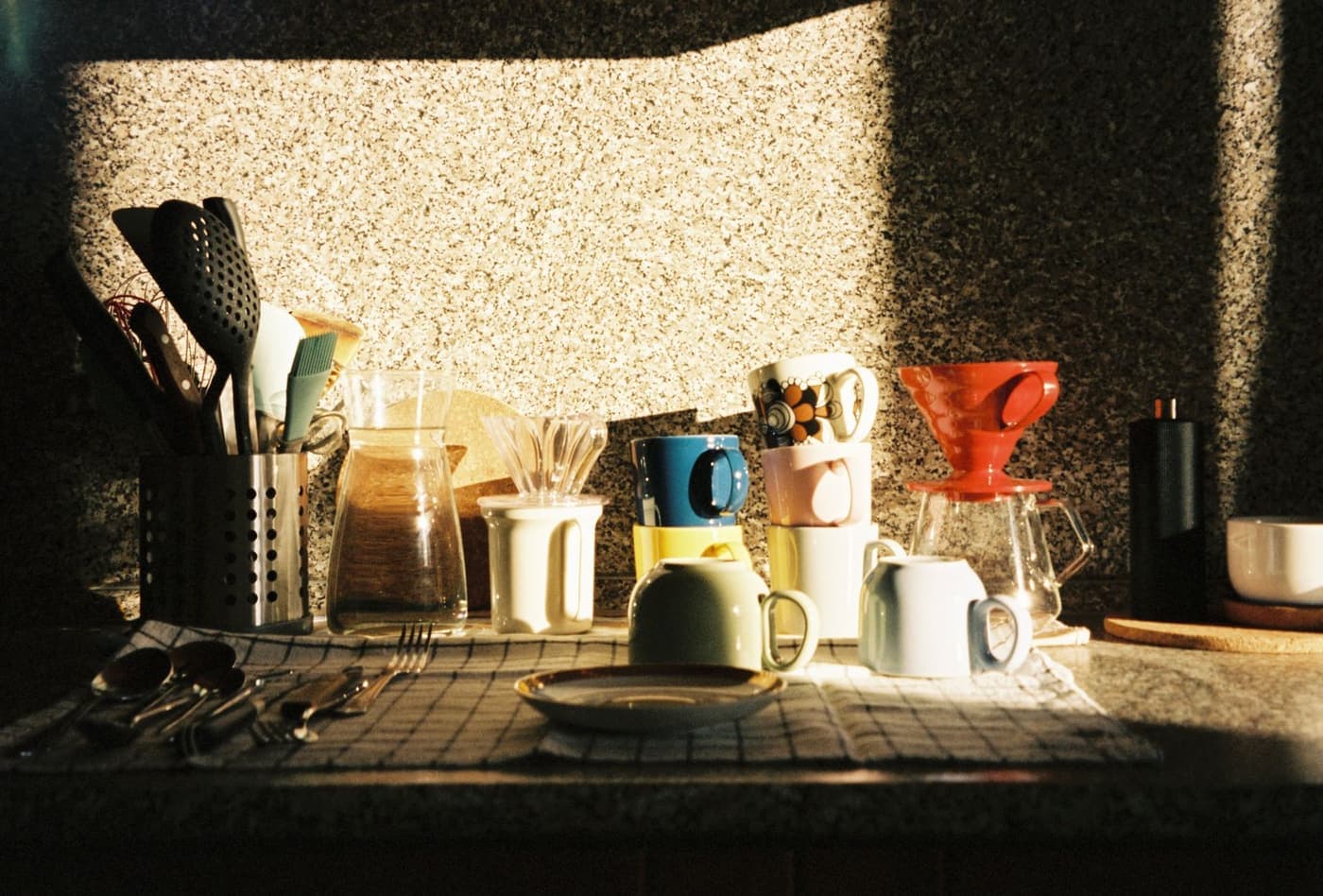 Morning light across a kitchen table set for coffee.