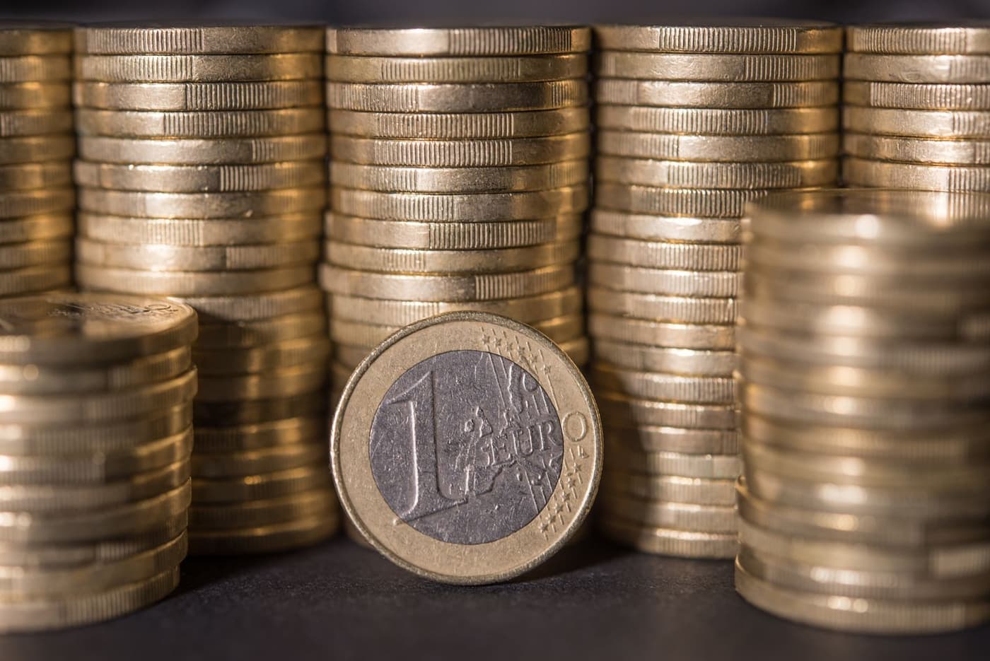 Coins stacked steadily upward in close-up.