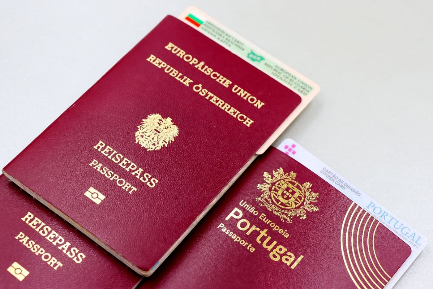 Passports and identity cards laid out on a desk.