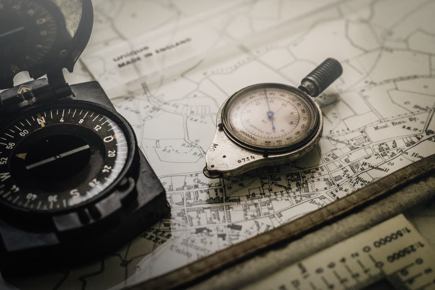 Vintage brass compass resting on an old map