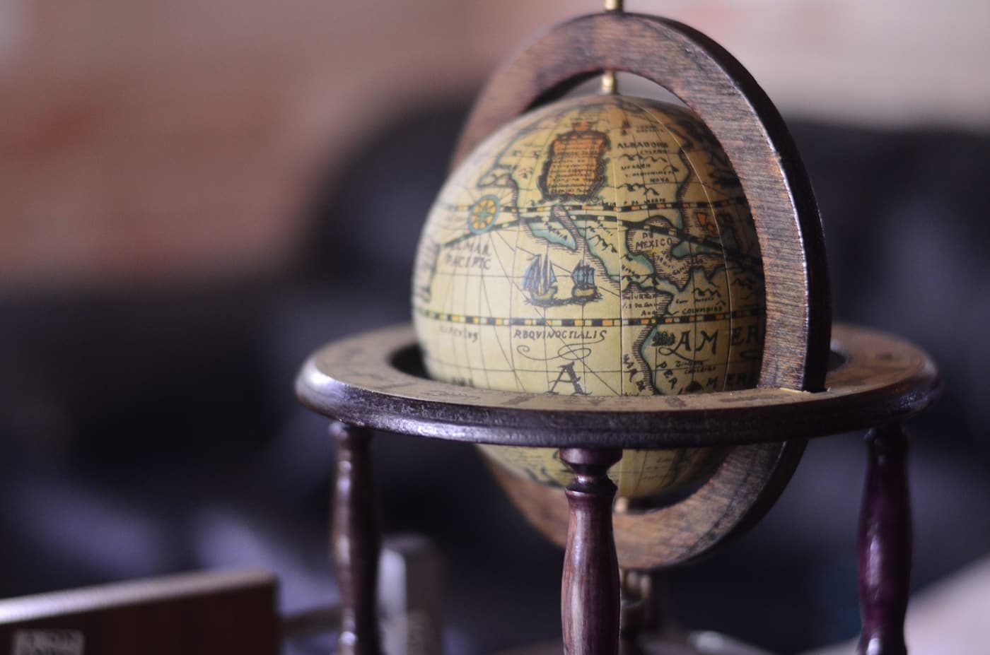 Close-up of a vintage wooden globe with antique map detail