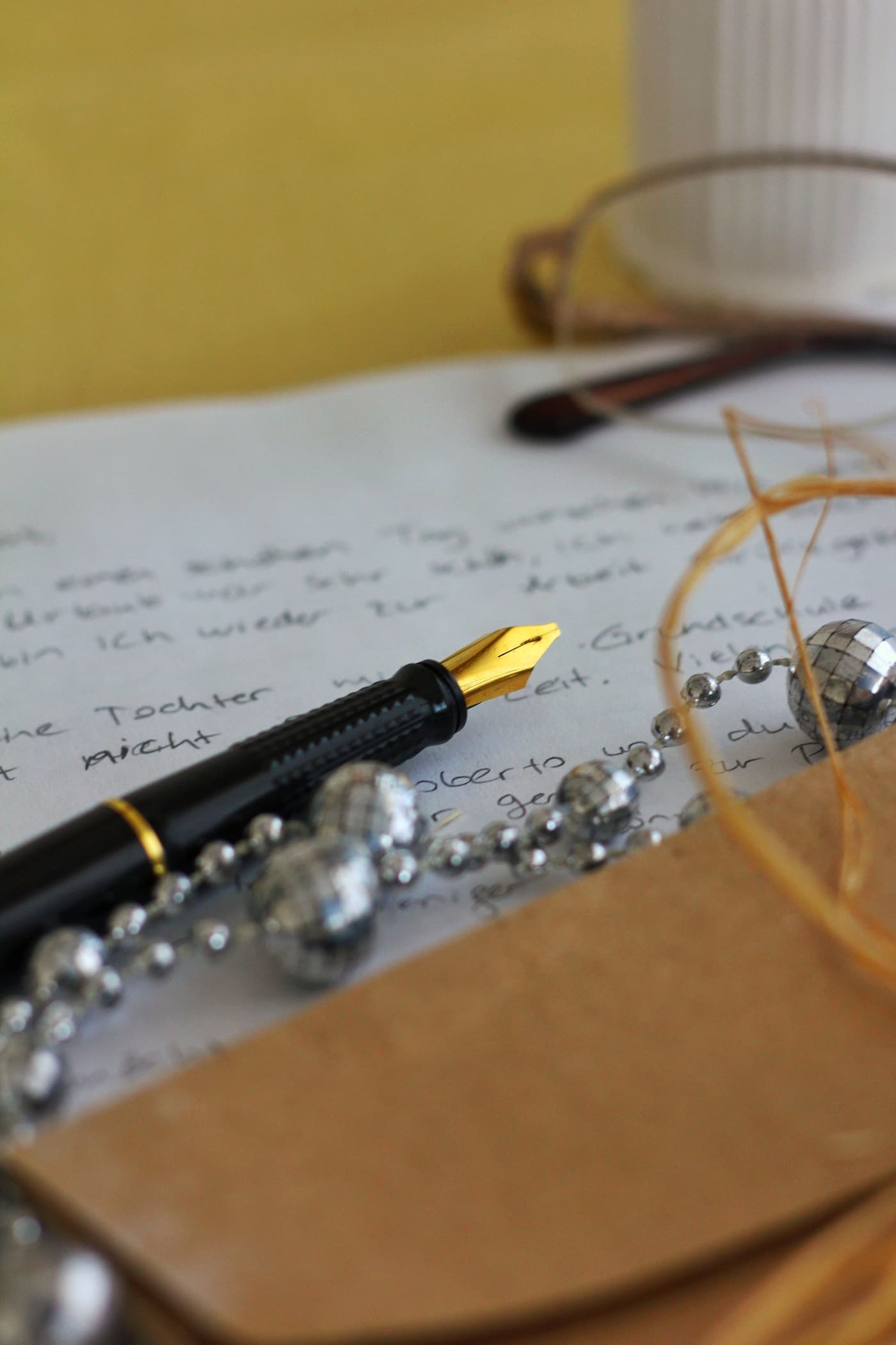 Writing desk with a fountain pen, handwritten letter and desk accessories