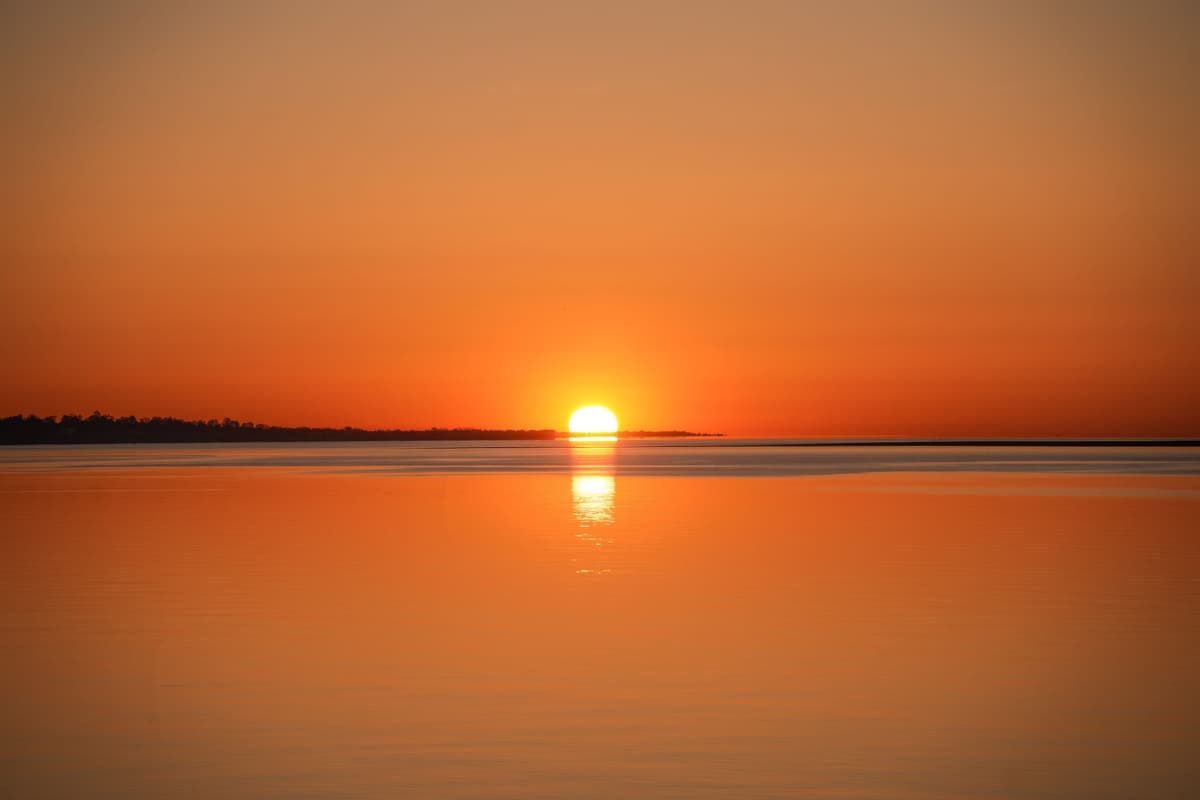 Sunrise over a calm sea horizon